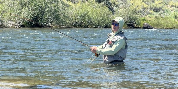 Person fishing in a river.