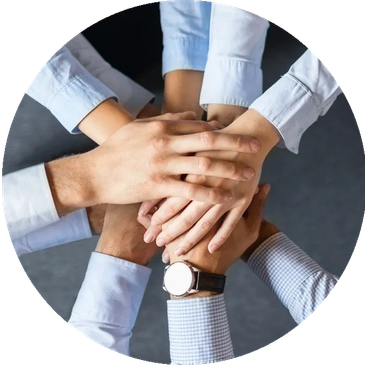 Multiple hands stacked together showing teamwork and unity.