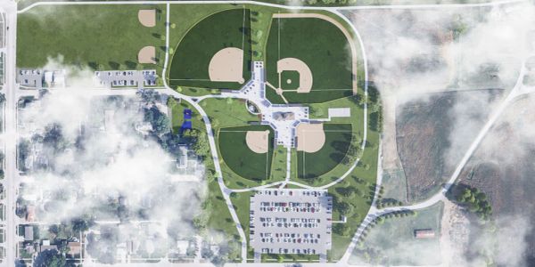 Aerial view of a park with multiple baseball fields and parking lots.