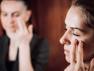 Emotional freedom technique session therapy, hands tapping on the face and body