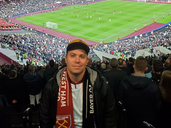 A soccer fan in the stands of a soccer match.