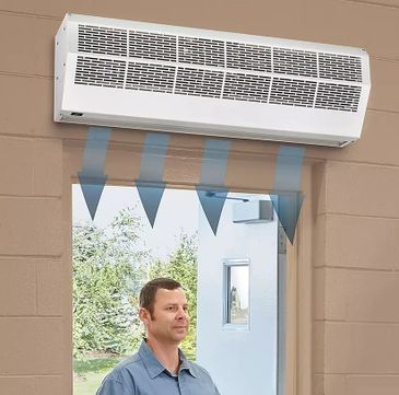 Air curtain installed above a door to control airflow.