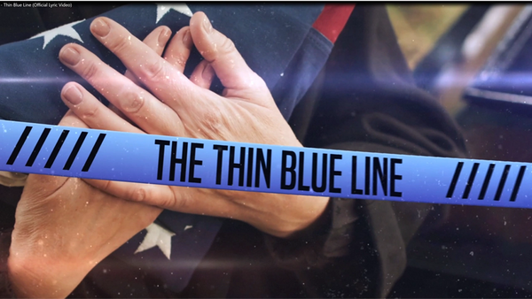 Thin Blue Line (Official Lyric Video) thumbnail image of family member holding ceremonial flag.