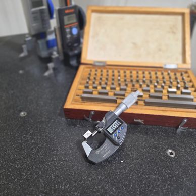 Digital micrometer on a granite surface plate.