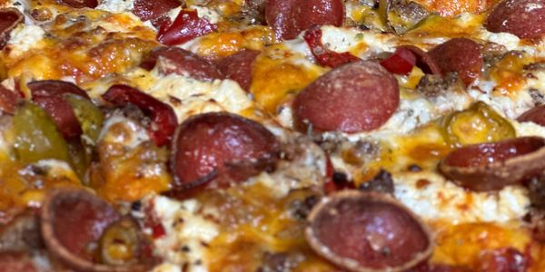 A close-up picture of a delicious pizza with cup n char pepperoni and cheese browned to perfection.