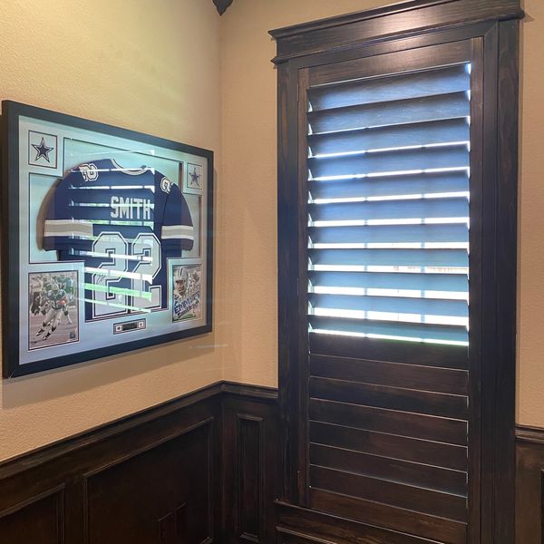Framed Dallas Cowboys jersey with number 22 and name Smith on a beige wall.