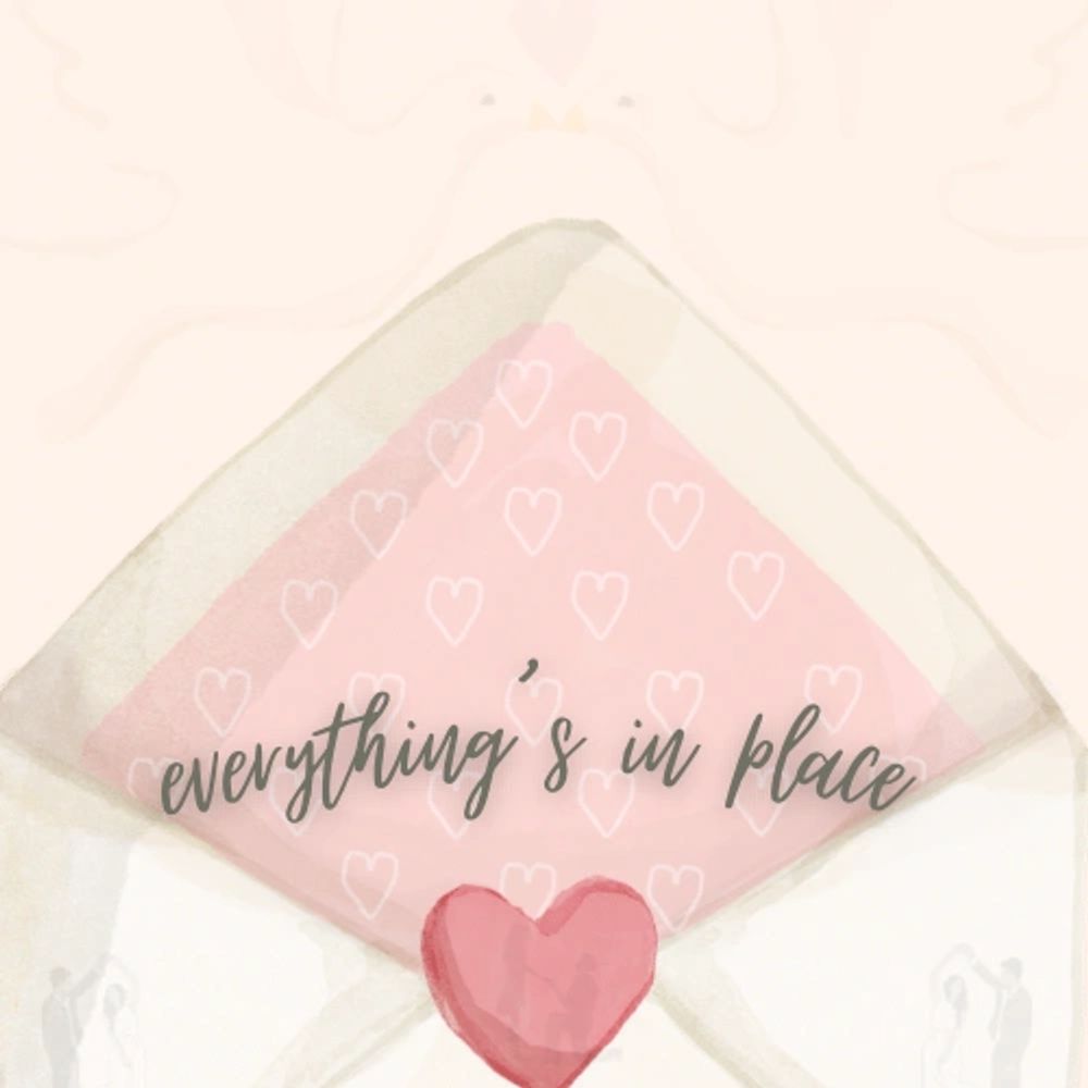 A pink envelope with hearts and the phrase "everything's in place."