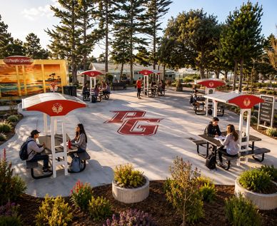 Outdoor seating area with shade umbrellas and people.
