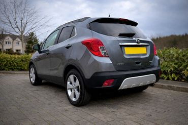 Rear view of a gray Vauxhall Mokka parked on a driveway.