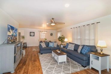Cozy living room with blue sofas and warm lighting.