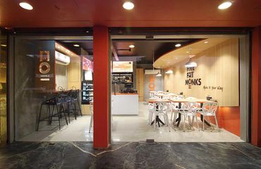 Modern dessert cafe with stylish seating and bright lighting.