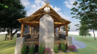 Modern wooden patio with a stone fireplace and lush greenery.