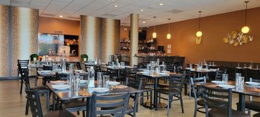 Modern restaurant interior with neatly arranged tables and chairs.