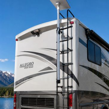 Back view of Allegro Open Road RV near water and mountains.