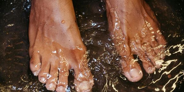 Two feet submerged in shallow water.