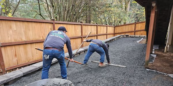 CKLD crew preparing a compacted gravel base for a professionally built landscape installation.