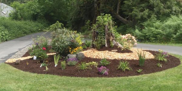 PNW garden with colorful plantings, natural wood and sustainable landscape design.