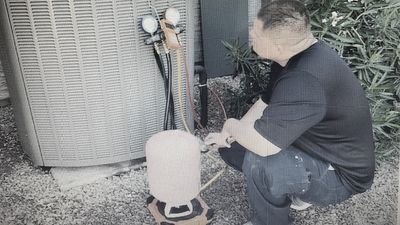 Technician Recharging a system after it had failed 
