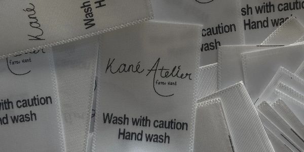 Close-up of white clothing care labels.