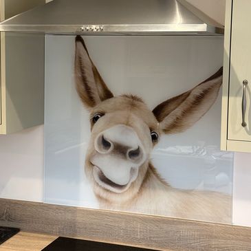 Cheerful donkey face on kitchen backsplash.