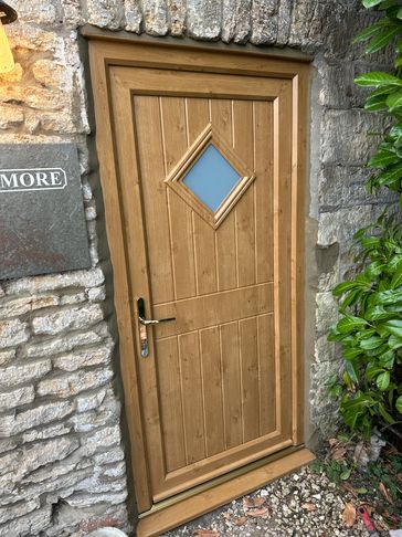 Wooden door with a diamond-shaped window.