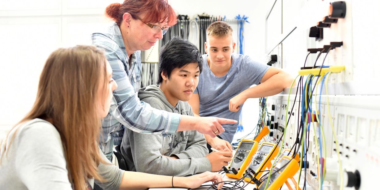 A group of young people in technical vocational training with teacher