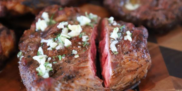 Juicy steak topped with garlic and herbs.