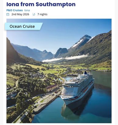 Luxury cruise ship docked in a scenic fjord surrounded by mountains.