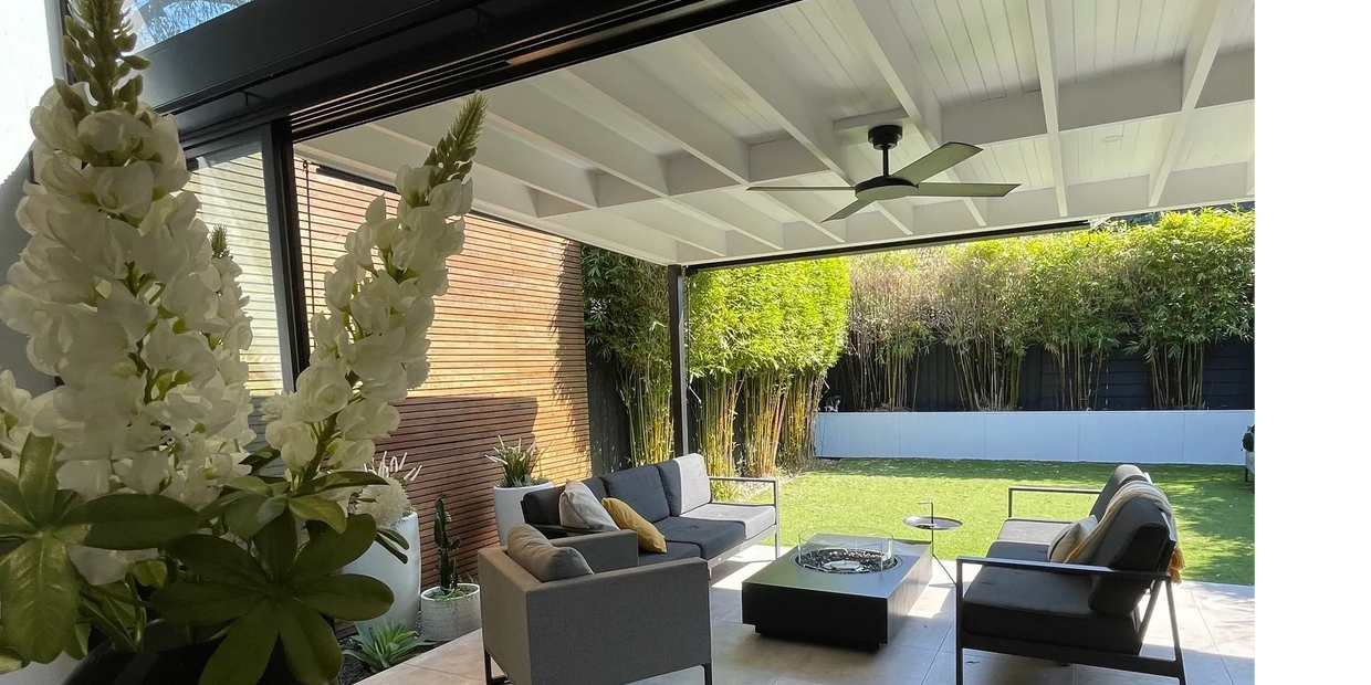 Outdoor entertaining area under a covered patio roof with stone feature tiles