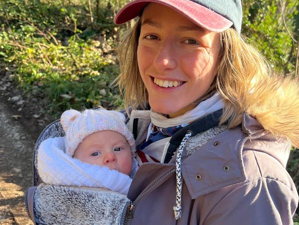 Proud mum carrying her newborn baby