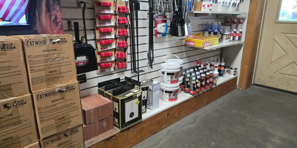 Store shelf displaying fire-starting supplies and tools.