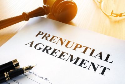 A prenuptial agreement document with a gavel and pen.