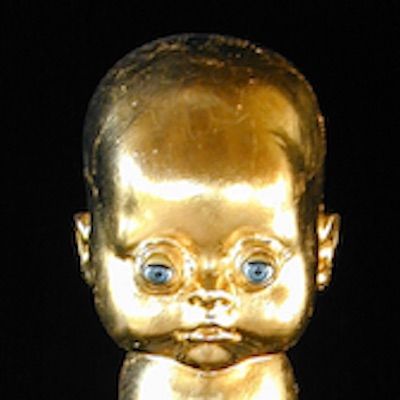 Mixed media doll. Plastic doll/doll parts, adhesives, paint, gold, wood.