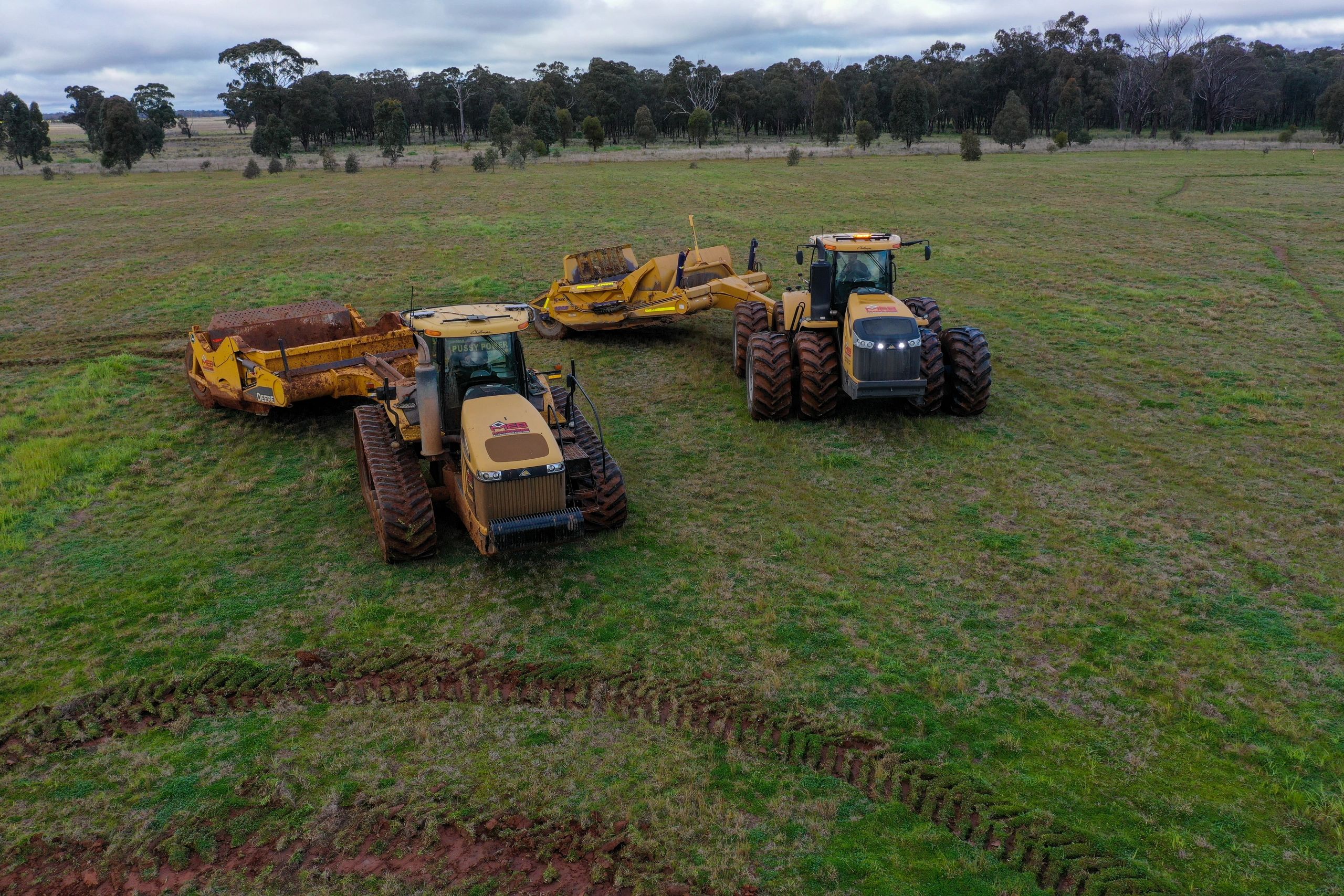 Tracked and wheeled tractor scrapers — aerial view