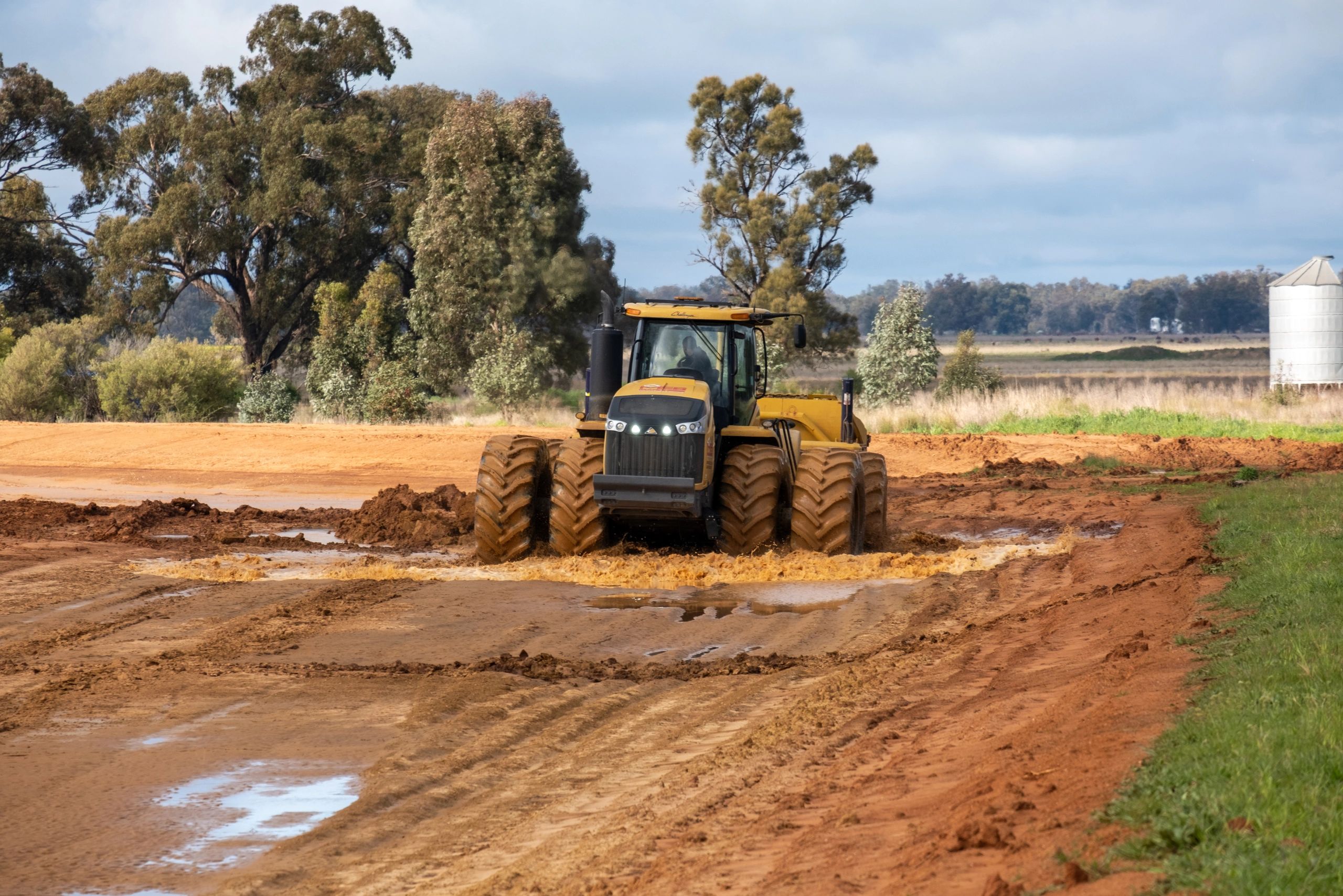 Tracked tractor scraper in paddock