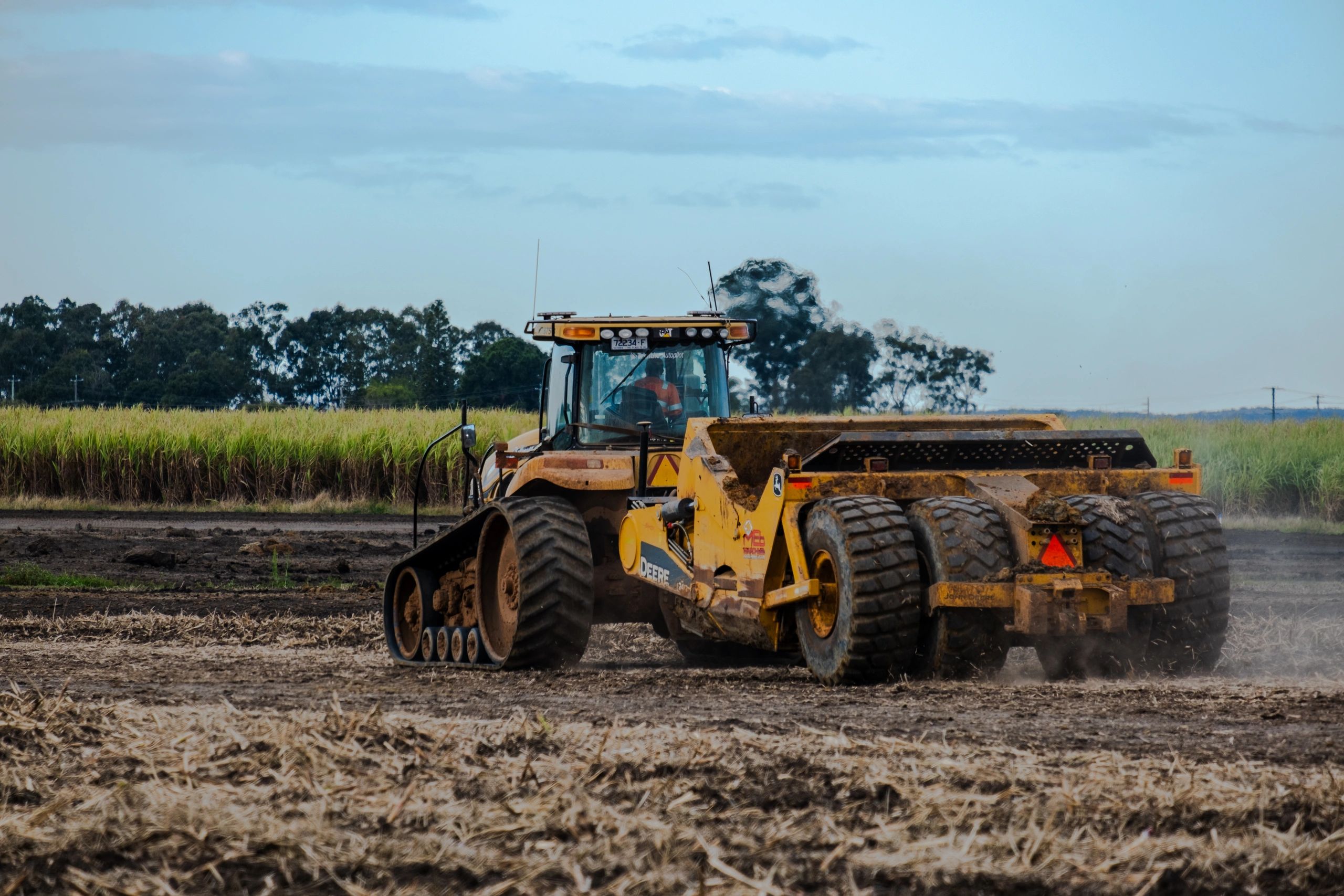 Tracked tractor with twin scrapers