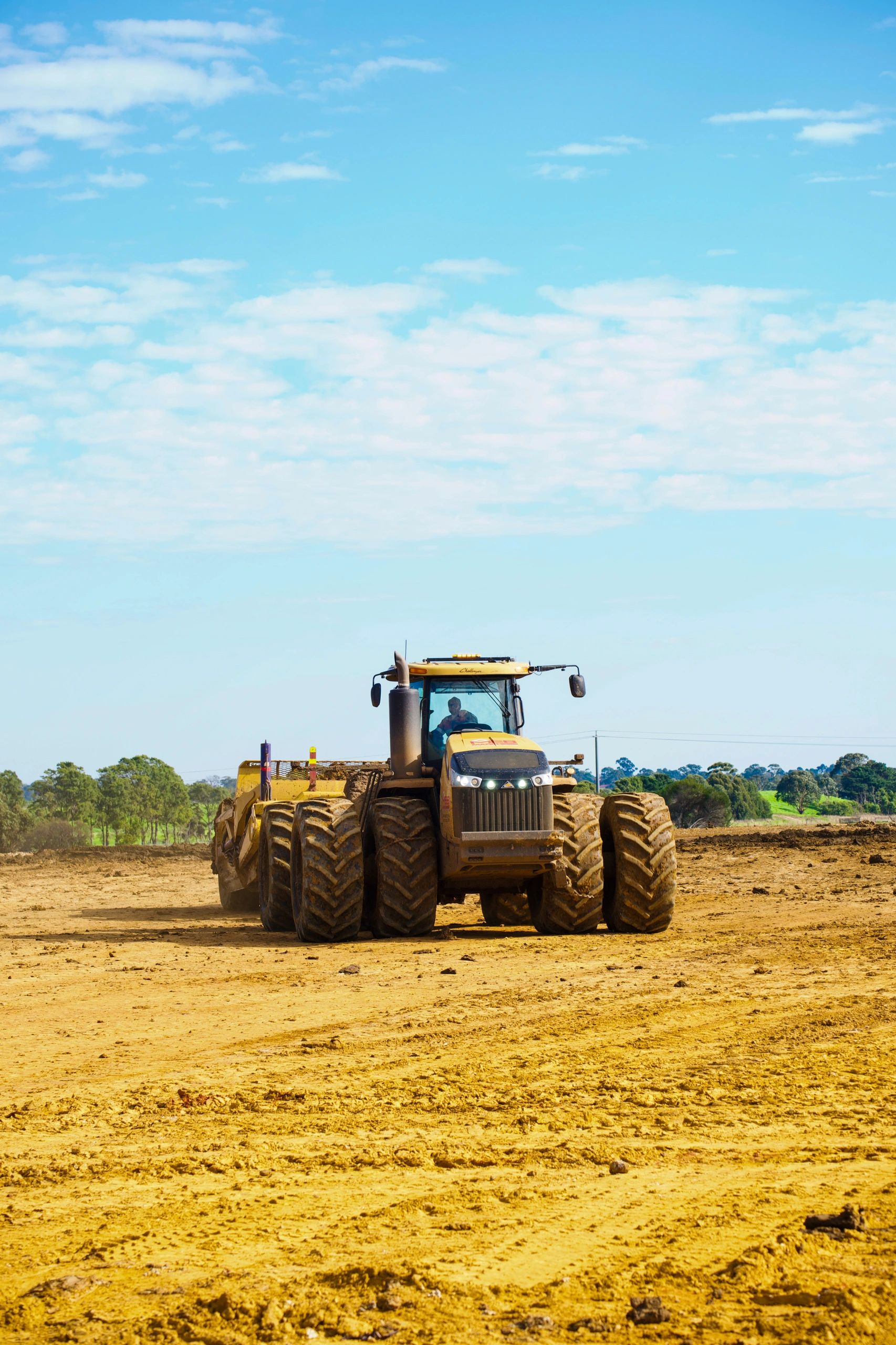 Challenger wheeled tractor towing a scraper
