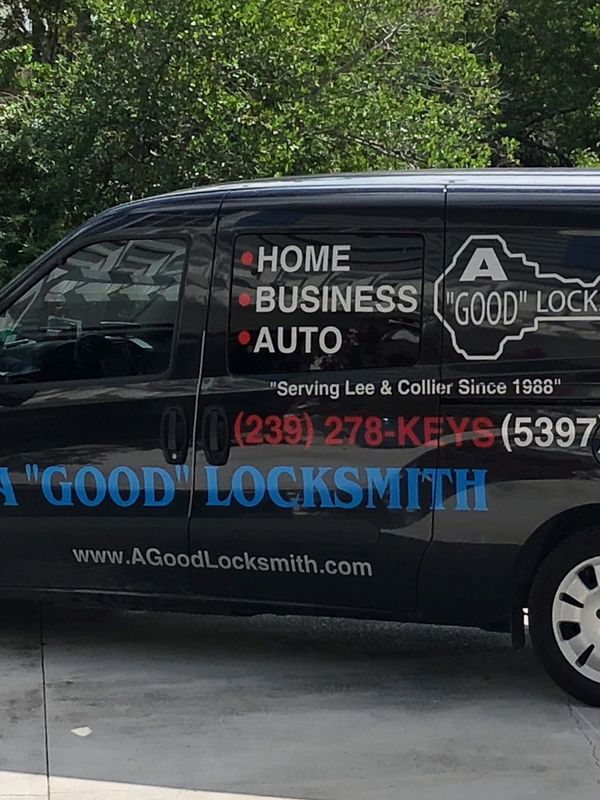 Black locksmith service van with business details and contact info.
