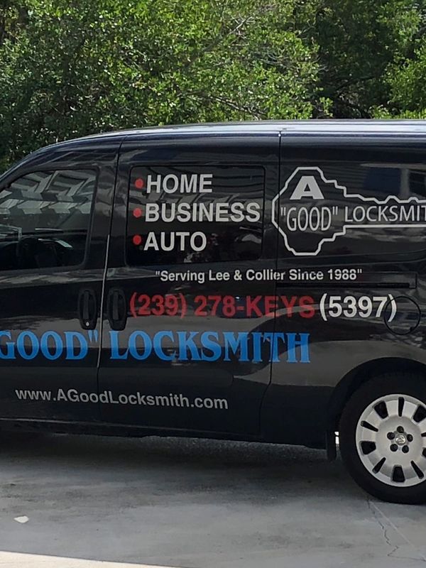 Black locksmith service van with business details and contact info.