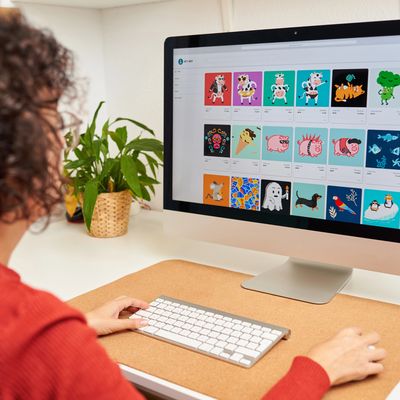 Person browsing colorful NFT art collection on a desktop computer.