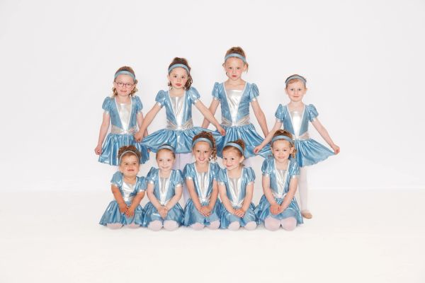 Group of young girls in blue dance costumes.