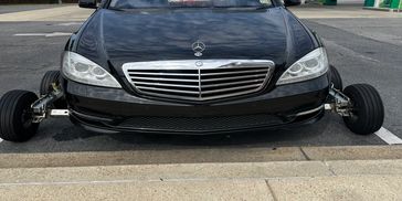 Luxury car missing its front wheels.
