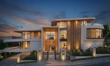 Modern luxury house with warm lighting at dusk and two people at the entrance.