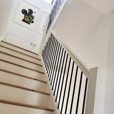 Modern white staircase with black railings