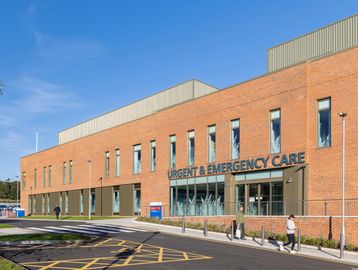Modern brick building housing an urgent and emergency care center.