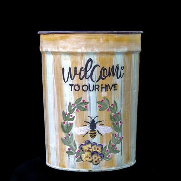 Painted tin with bee and welcome message.