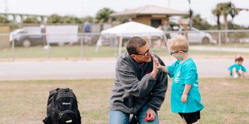 Kid high fiving teacher