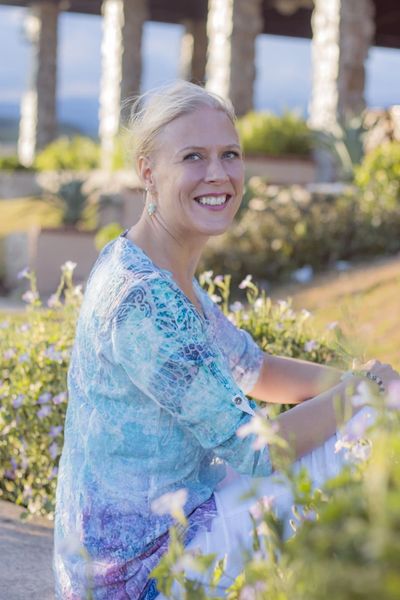friendly woman surrounded by flowers