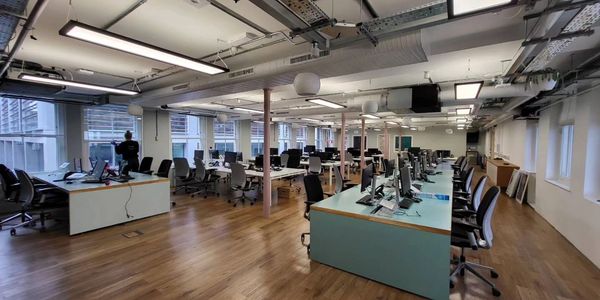 bright office with wooden flooring tables and chairs. office cleaning. deep cleaning. commercial. 