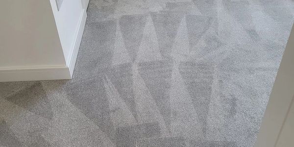 light grey carpet with triangular marking. carpet cleaning. flooring clean. stain removal.